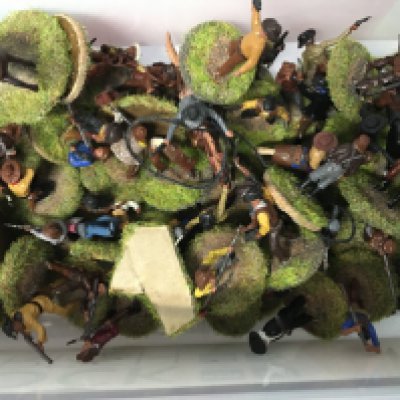 A collection of small vintage figurines including people and animals.