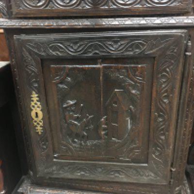 A oak cupboard the raised back above a single carved door. NO RESERVE