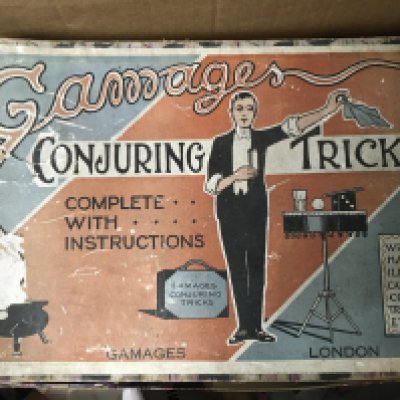 A collection of antique toys and games including Gamages Conjuring Tricks, a battery operated Patrol Phone, a sma,, RMS Titanic model and an empty Corgi box.