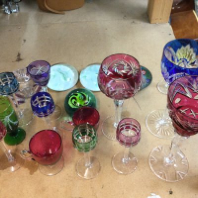 A collection of coloured glasses, paperweights etc