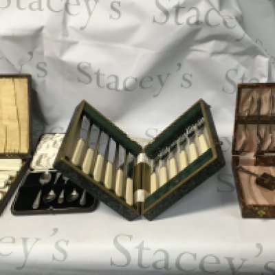 A collection of 4 small antique cutlery sets, including knives, forks, spoons and a large knife.