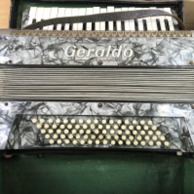 A vintage cased Geraldo accordion.