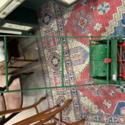 A vintage cast iron and painted push roll mower. (D)