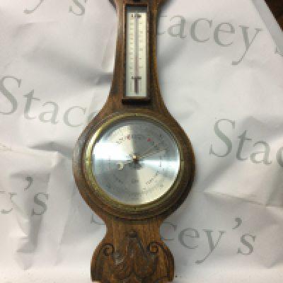 A collection of mixed items including an antique barometer, an antique clock, a wooden countryside African frame and an oil and canvas painting, Totopoly and a vintage porcelain blue and white antique jug.