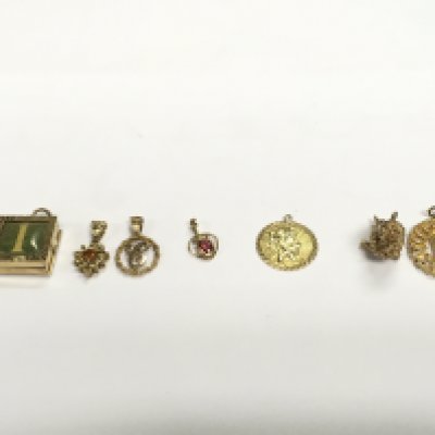 A collection of 9ct charms and pendants. 18.03g Postage A