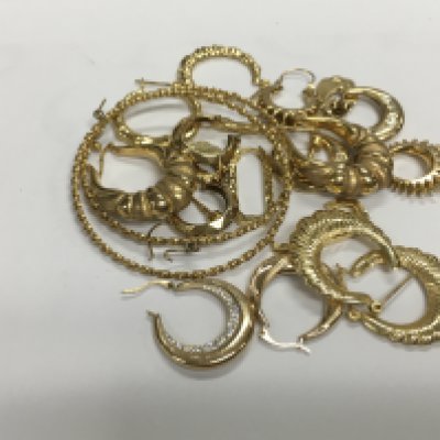 A large collection of assorted 9ct gold earrings. 26.20g Approx