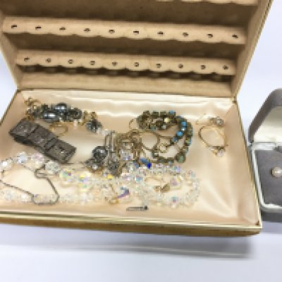 A box of costume jewellery including gold and silver examples. Postage B