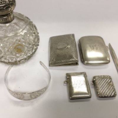 A collection of assorted silver items including silver topped scent bottle cigarette cases Vesta cases silver bracelet and a silver pencil.