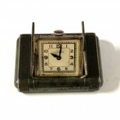 Tavannes silver engine turned purse watch, import hallmarks, with end pushers opening spring loaded doors revealing the square silvered dial.