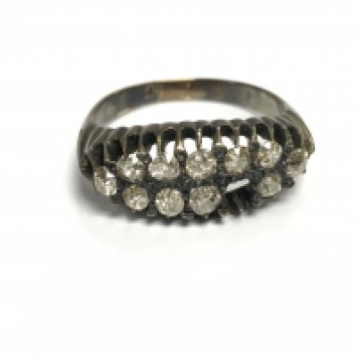 An unmarked gold diamond cluster ring with approximately 0.50ct diamonds. One stone missing. Size R and 4.35g