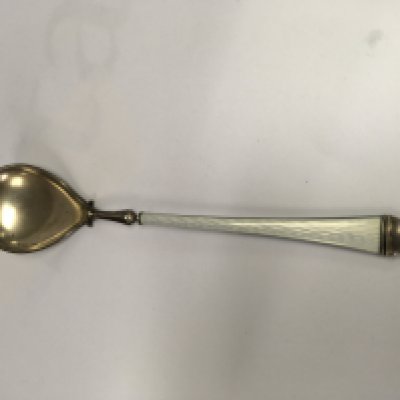 A silver and enamel spoon with tapering handle . NO RESERVE