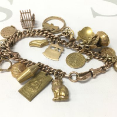 A 9ct gold charm bracelet with mixed charms. Approx weight 39.02 grams.