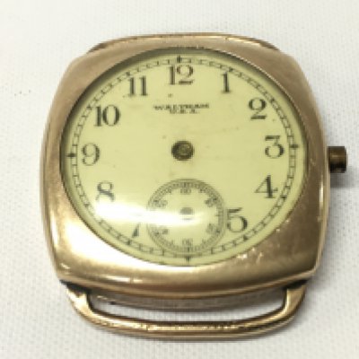 A yellow metal unmarked cased Waltham wristwatch.