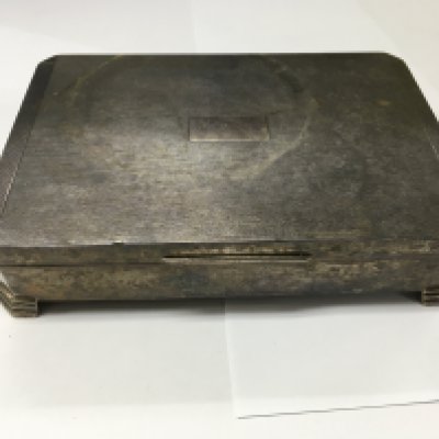 A silver tabletop cigarette box.