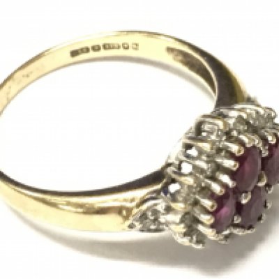 A 9ct gold ring set with rubys and small white stones. Approx size R, Approx weight 3.33 grams.