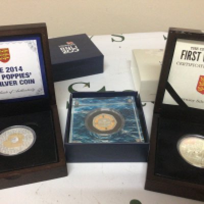 Two Silver proof Five pound coins 100 Poppies Centenary of the First World both one ounce and a RNLI 200 year slabbed silver 50 pence.
