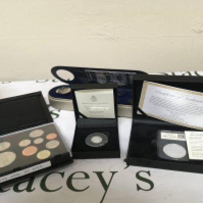 A collection of coins comprising a cased Silver Proof Sovereign a one ounce Silver Britannia coin 2009 U.K. Coin proof set and a Royal Mint Time Capsule Coin set.