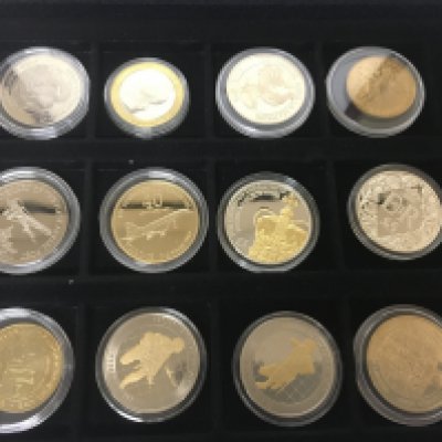 A collection of mixed commemorative coins including some silver proof and gold plated nickel coins.