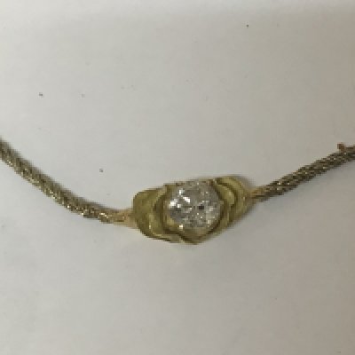 WITHDRAWN - An 18carat gold pendent set with a brilliant cut solitaire diamond with attached 9carat gold chain.