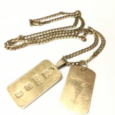 A 9ct gold ingot and medical pendant on a gold curb chain. Approx weight 29.34 grams.