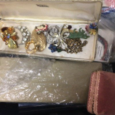 A box containing costume jewellery including some silver jewellery.