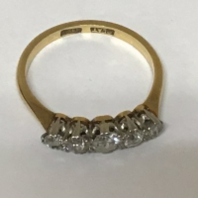 An 18carat gold ring set with a graduating row of five old cut diamonds ring size M weight 2.5g