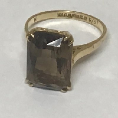 A 9carat gold ring set with a good sized smoked quartz of rectangular shape.