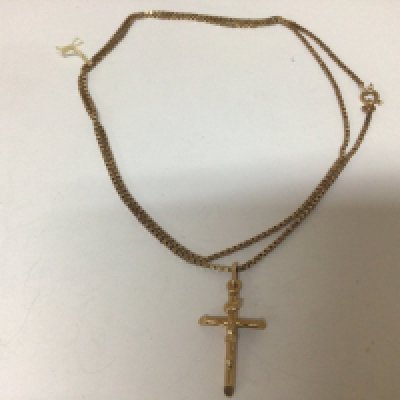 A 9carat gold crucifix pendent with attached 9carat gold chain 8g
