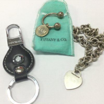 A silver Tiffany and Co silver necklace two key rings . Postage catA