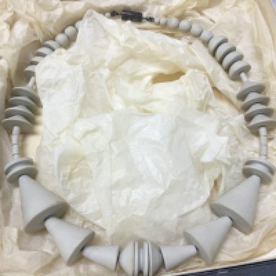 A boxed Wendy Ramshaw (1939-2018) necklace with Wedgwood hand turned beads ,a silver clasp hallmarked maker J.W and signed WR. 16cm wide approximately . Postage category B