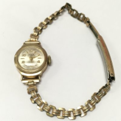 A 9ct gold cased ladies Avia watch with a gold plated bracelet . Postage catA