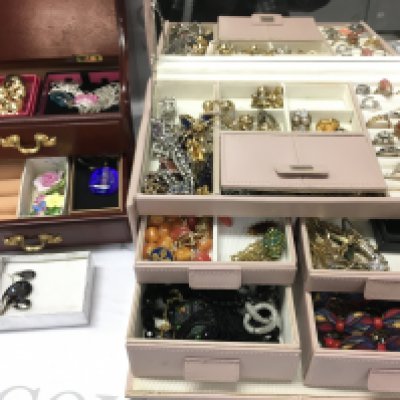A large collection of costume jewellery including two boxes of brooches, necklaces, earrings, rings etc . Postage catC