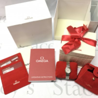 A boxed ladies Omega De Ville Prestige watch with paperwork . Postage category B