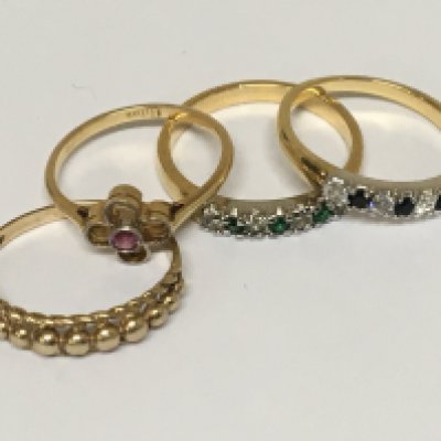 An 18cart gold ring set with a ruby weight 1.8g two matching unmarked rings set with alternating stones and a 9carat gold ring 1.5g
