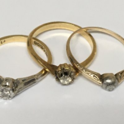 Three 18carat gold rings set with Small Solitaire diamonds weight 7g