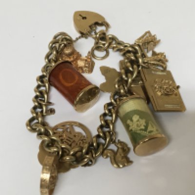A 9carat gold charm bracelet with several attached 9carat charms.total weight 48.5g