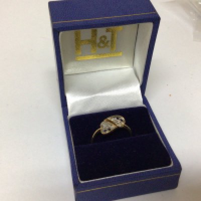 A 9carat gold ring set with a pattern of sapphire and small diamond in shaped naturalistic heart form weight 1.6g