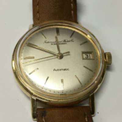 A vintage gents automatic IWC watch in an 18ct case.