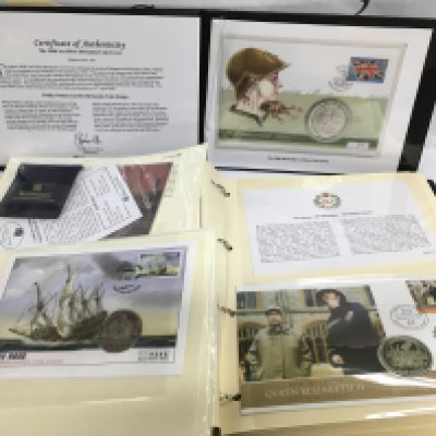 An album of coin covers including some silver examples. Shipping category B.