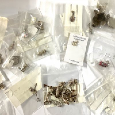 A Large collection of sterling silver charms. (A)