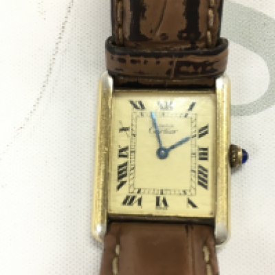 A vintage Cartier Tank must de watch. On replacement strap. Comes with a box and booklet.