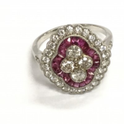 A platinum Belle Epoque style ruby and diamond quatrefoil ring set with diamonds and rubies. Diamonds 1ct approx and rubies 0.78ct approx. Size N 1/2
