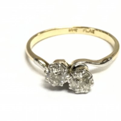 A vintage platinum and 18ct yellow gold double twist ring set with two diamonds. Diamonds approx 0.75ct and size R