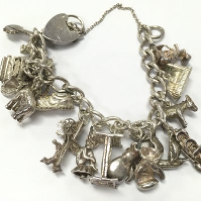 Silver charm bracelet , 53.9g total weight. Postage category A