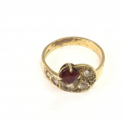 A ruby and diamond 18ct gold ring. Size X and 7.35g Postage B