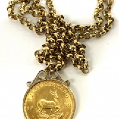 A 1980 1/2 South African gold Kruggerand, within and 9ct gold coin mount and chain. 40.34g (A)