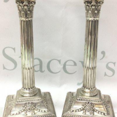 A pair of silver hallmarked corinthian column Candlesticks ,23cm tall.postage category B