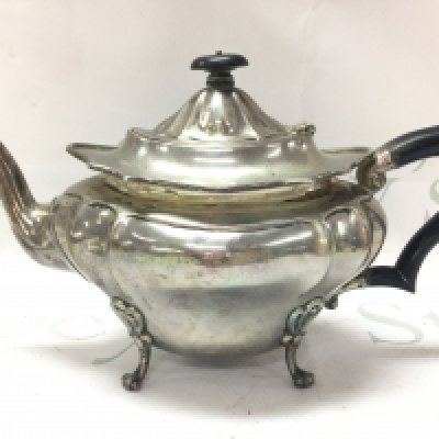 A silver hallmarked teapot with paw feet marked London 1910. Postage cat B