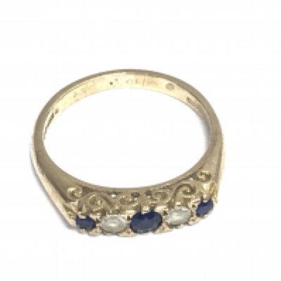 A 9ct gold ring set with simulated sapphires and white stones. Size L 1/2 and 2.64g