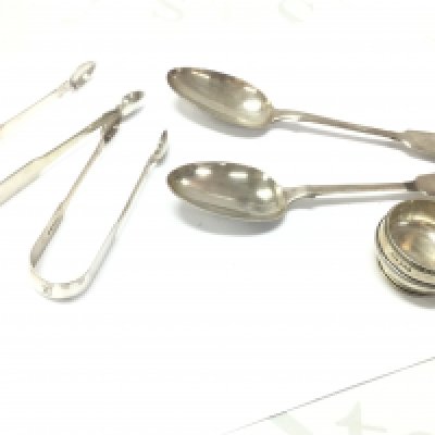 Silver hallmarked items- A pair of Georgian serving spoons, two sugar tongs and a salt bowl